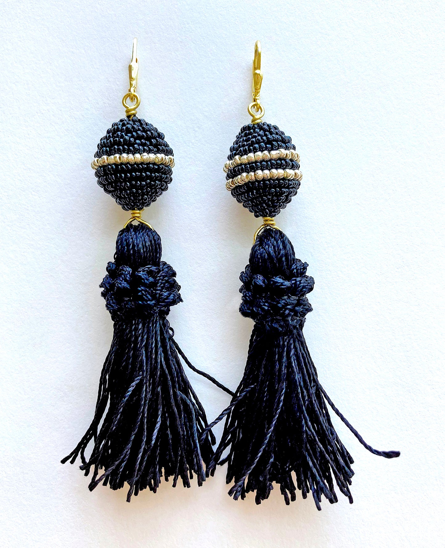 Dazzling 'Tassel' earrings are made of small wool balls embellished with black & white glass micro beads, gold plated leverback, and brass wire black tassels.