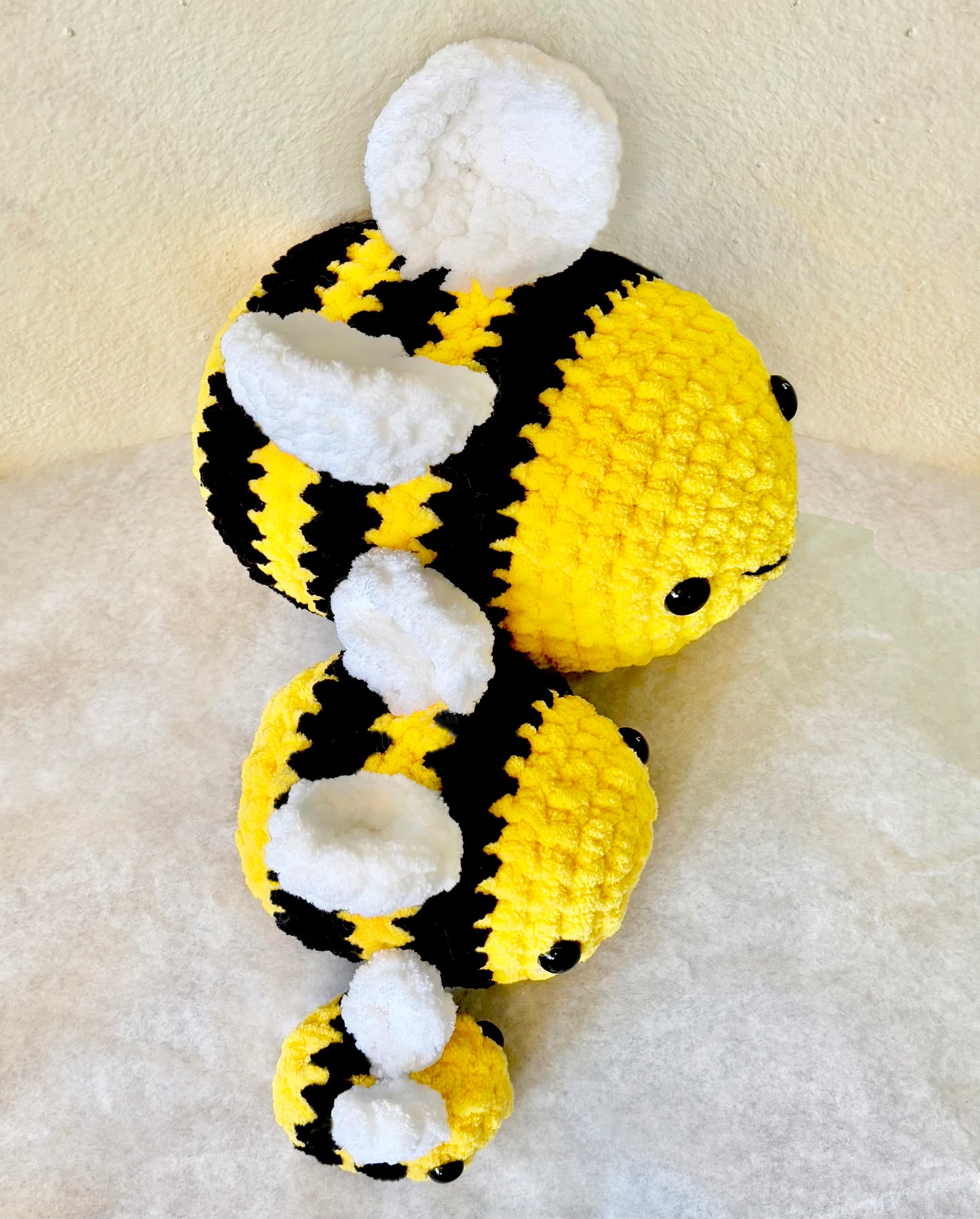 Busy Bumblebee crochet plushie collectibles are hand crocheted by Anya, MarVia Square's youngest artisan. Made with the softest, plush acrylic yarn, these adorable bumblebees have black stripes on a yellow body, with white wings, and mushroom bead (plastic) buttons for the eyes. Dimensions: Small: 3.5"long x 3"tall, Med.: 6"long x 4.5"tall, Large: 8.5"long x 6.5"tall Spot treat with mild soap Consciously made in California