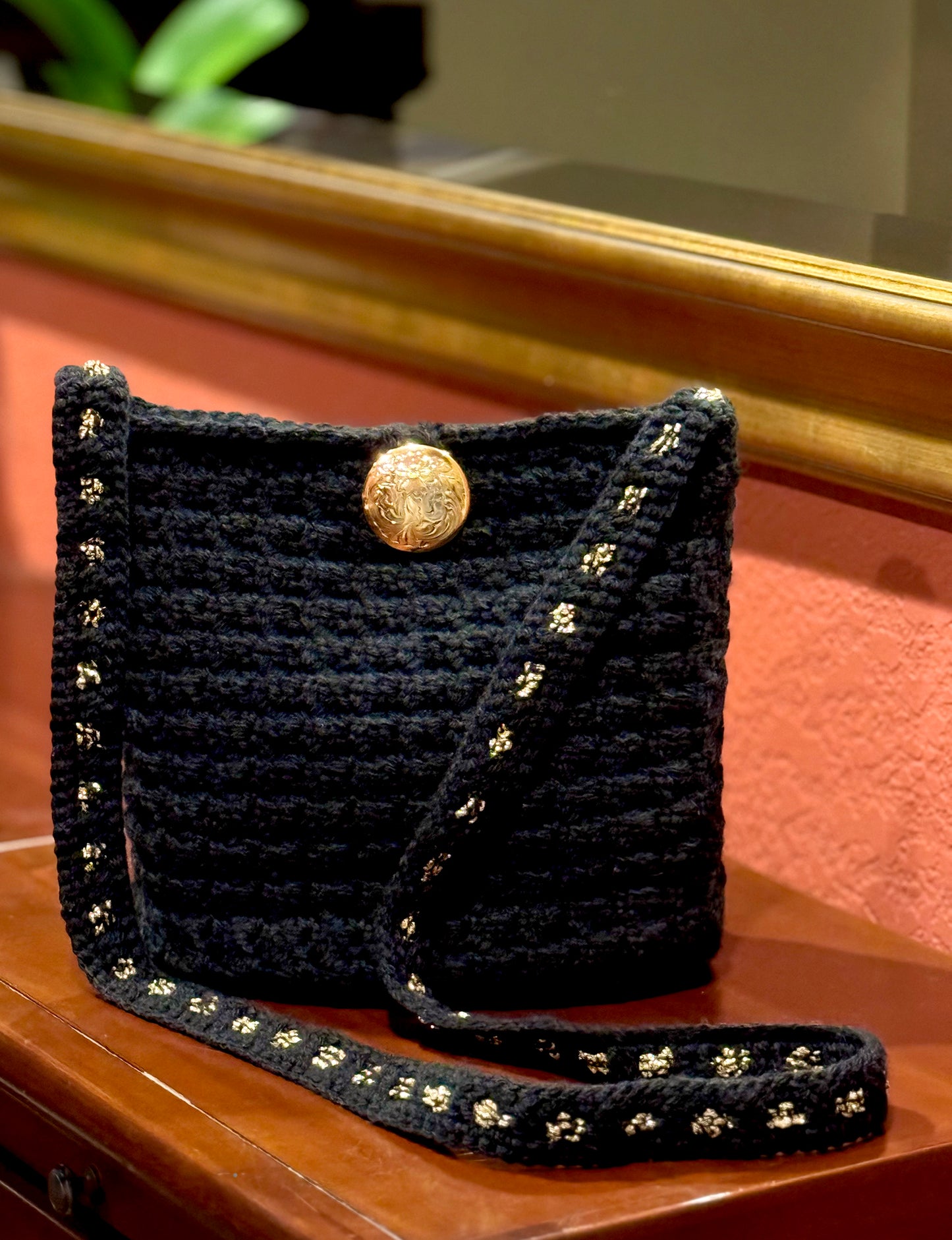 Evening sparkle of silver or gold add a beautiful accent to these vintage evening crochet bags. Each bag unique in reflecting the beauty of expert craftsmanship with up-cycled acrylic & metallic yarn, button closures from the 60s, black satin lining, and shoulder strap style that can also be worn cross body. Dimensions: Silver 'Elle' Bag: 8.5" long, 7" high, 4.5 wide, 16"strap Gold 'Eloise' Bag: 9"long, 10" high, 5" wide, 18" strap (from shoulder to top of bag) Dry Clean only Available for custom color orde