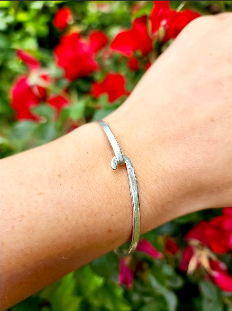 This unique, sterling silver bracelet design by Randi M., symbolizes the loving, eternal bond with loved ones. Add a personal touch with your loved ones' name(s), words of inspiration, or a favorite quote, that can be hand stamped on either the outside or inside of the bracelet. Simply send an email with your request and allow 2-3 days to create your personalized piece. Light weight, easy hook & unhook design 7" diameter Handmade in California