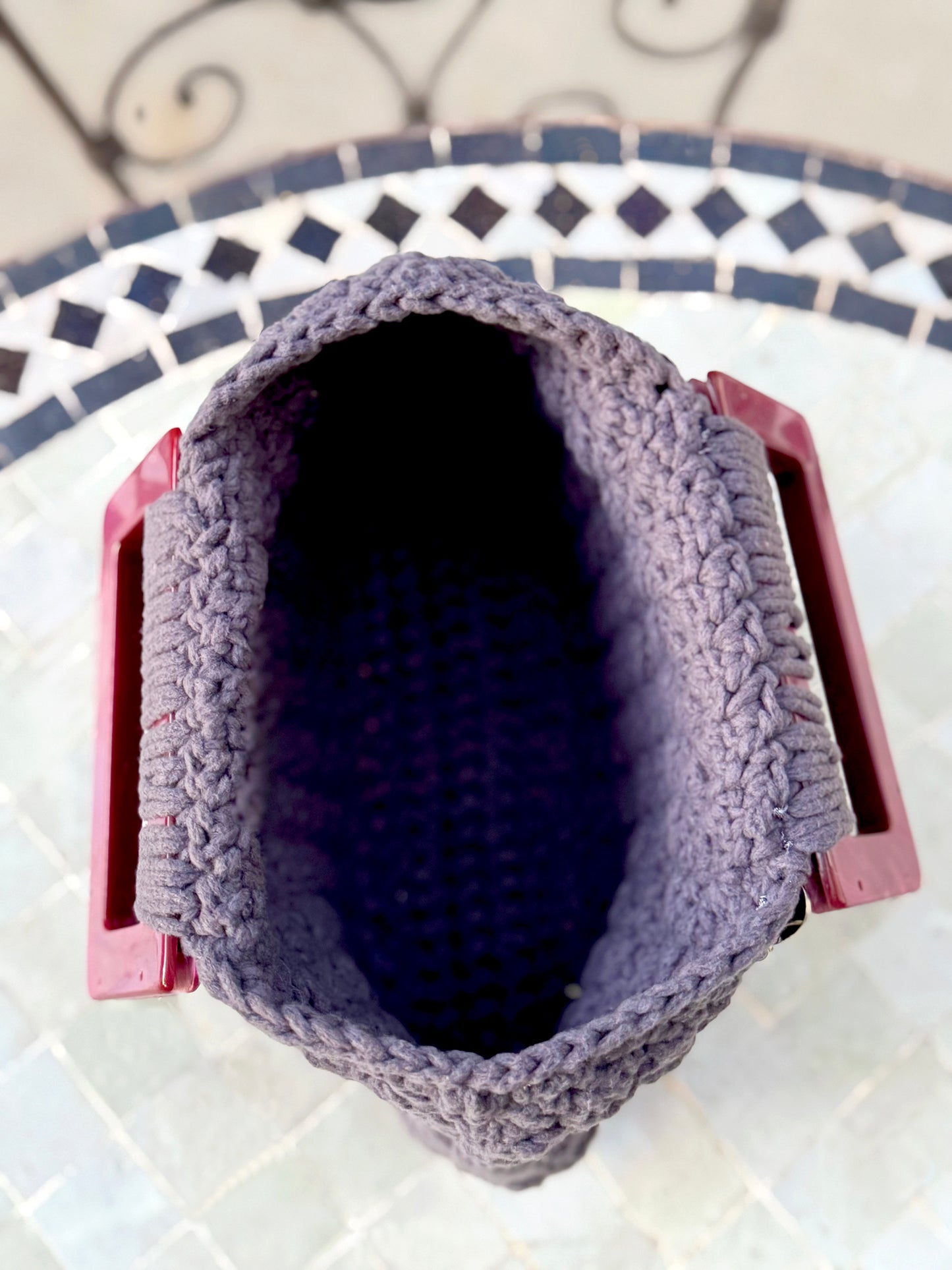 French is the language of Love, and the L'Amour vintage crochet bag reflects the beauty of European expert craftsmanship. Adorned with stainless steel chains, heart engraved buttons, and dark pink, marbled Lucite handles. High quality, upcycled acrylic yarn in slate gray, crocheted in a secure binding pattern, insures no lining is needed. Dimensions: 10" long, 10" high (including handles), 3.5" wide Dry Clean only Consciously made in California