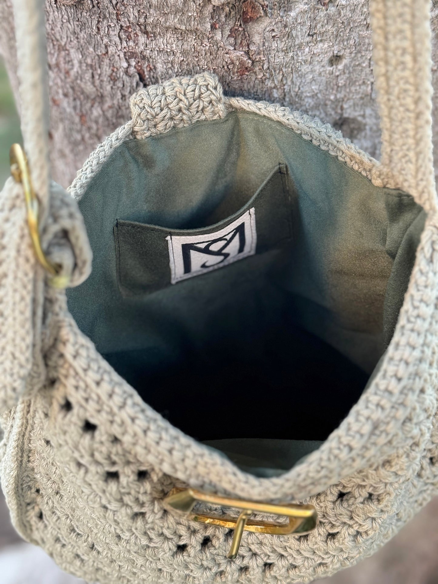Bohemian Chic, the Livia Boho Bag is a cross body, hand crocheted bag with adjustable strap and brass buckle closure. Color: Sage Dimensions: 12" Long, 11" High, 25" Strap length from shoulder Adjustable Strap: Can be adjusted 4" shorter or longer Consciously crafted in California