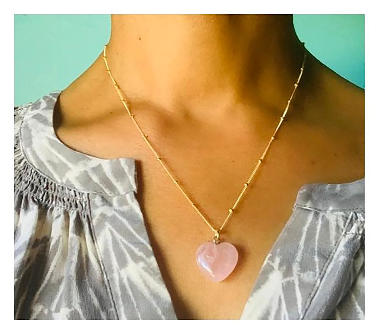 Corazon means 'Heart' in Spanish, and this rose quartz heart necklace is the perfect piece to bring more love into your life. Heart pendant measures 17mm x 16mm, 5m thick, and has a silver loop for the chain. Size may vary slightly from pendant to pendant. Gold filled, 18" satellite chain may be subst…