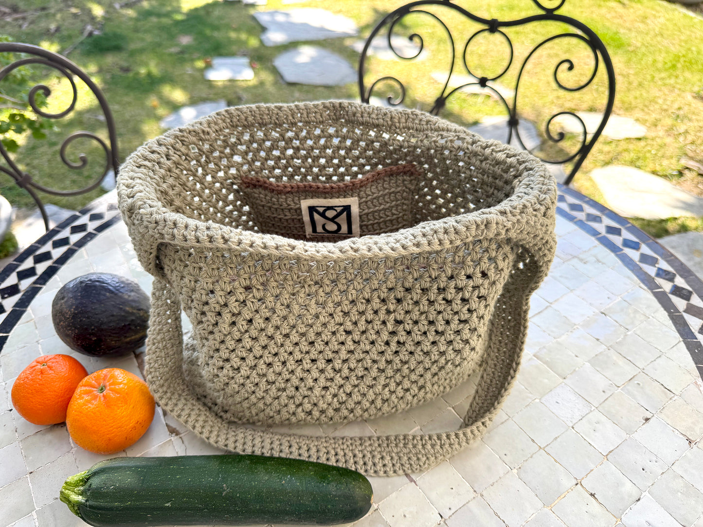 We love to support our local farmer's markets, which inspired us to create the Toulouse Market Bag. Hand crocheted with upcycled cotton blend yarn to ensure great strength and stretch, including inside pockets for your wallet and phone. Dimensions: 13" wide, 12" high, (26" high with shoulder strap) Hand wash with mild soap and cold water, or Dry Clean Consciously made in California