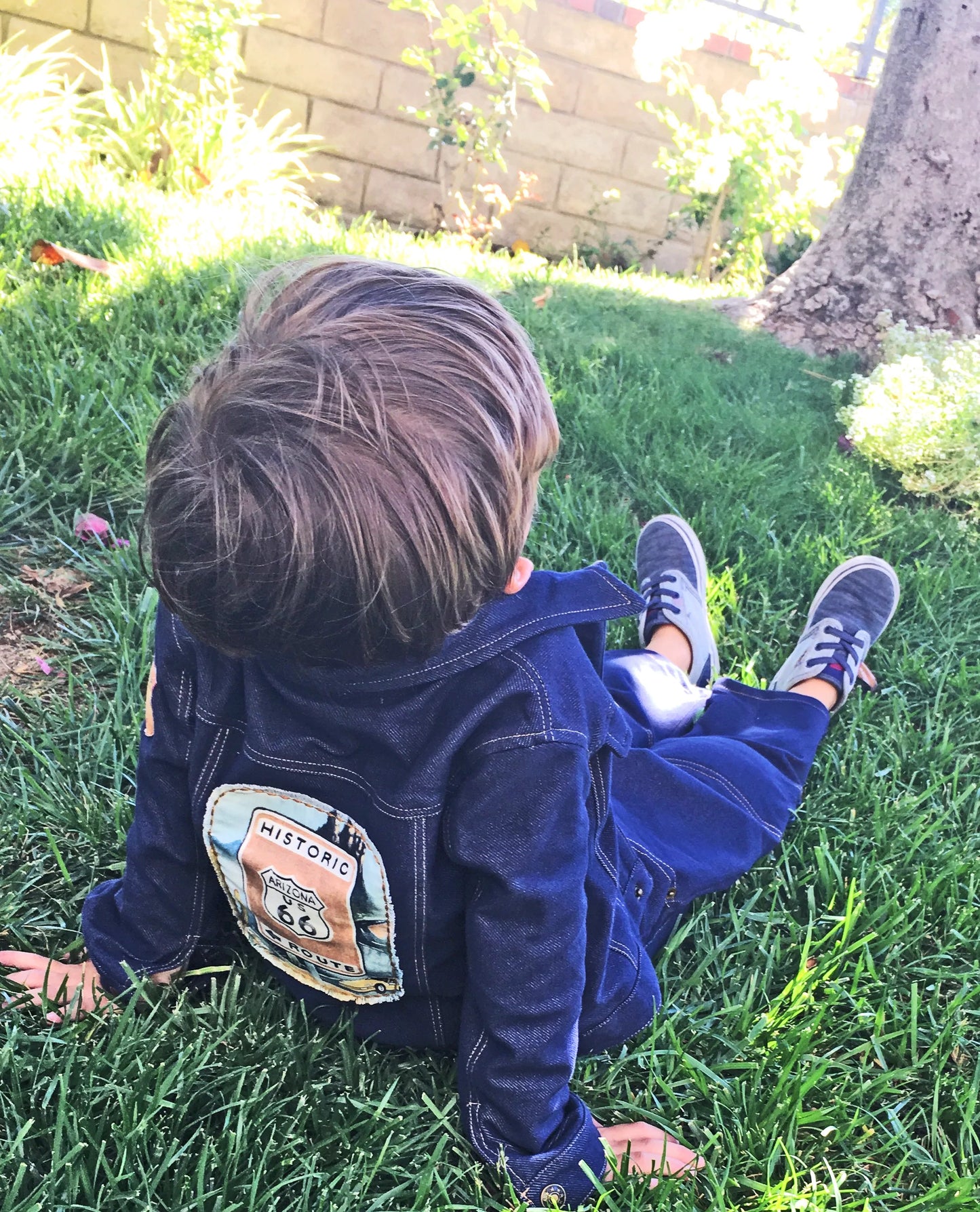 Your little explorer will be super comfy in our Route 66 denim knit jacket with cotton knit, stripe lining. Sleeves can easily be rolled up and secured with snaps on the cuff. Vintage print of Route 66 applique on the back and shoulder. Nickel free, antique bronze snap closures for easy on & off. Order one size larger for longer wear Machine washable, warm, delicate cycle Made in the Jammin' USA