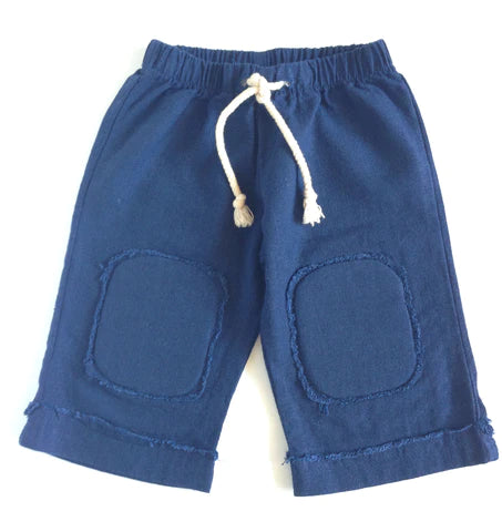 Casual crop pant made of soft, cotton linen with padded knee patches to protect tender knees. Elastic waist with decorative nautical cord and frayed edges on cuffed hem to create a cool beachcomber look. 100% Cotton Linen Wash Cold, Low Heat or Line Dry Consciously made in California