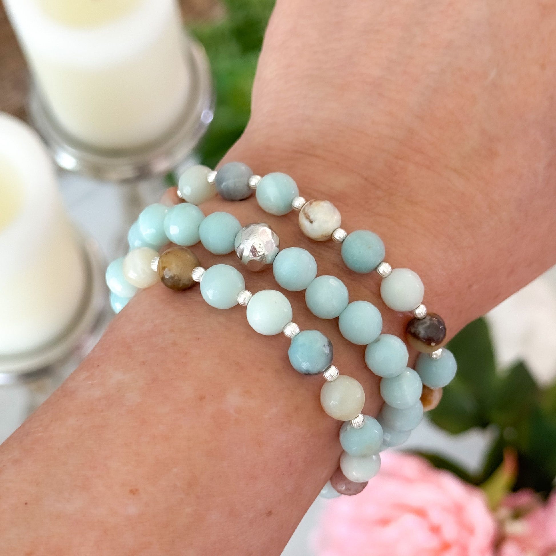 Feel good and look beautiful in 'Just Good JuJu' gemstone trio bracelets. The trio of Amazonite with sterling silver bead accents, has powerful healing properties, encouraging emotional balance, harmony, good luck and fortune. The trio of Rose Quartz and faceted petrified wood with 14k gold filled bead accents, has healing properties of calm, compassion and love. Each bracelet has stretch cord to fit most wrist sizes. Dimensions: Amazonite - (2) 8mm stones, silver bead accents, (1) 8mm stones with one 8mm s