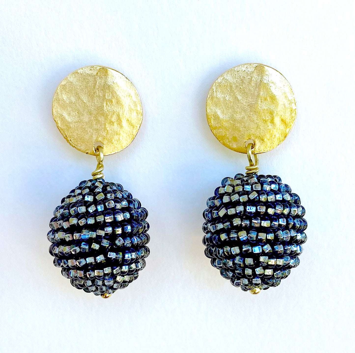 Artist, Iva Hladis, has created an exquisite collection of elegant beaded earrings that will stand out in any event. Black Diamond - Black wool ball embellished with glass micro beads, gold plated earpost & headpin. Length: 1.5" Ball size: 7/8" Disc: 4/8".