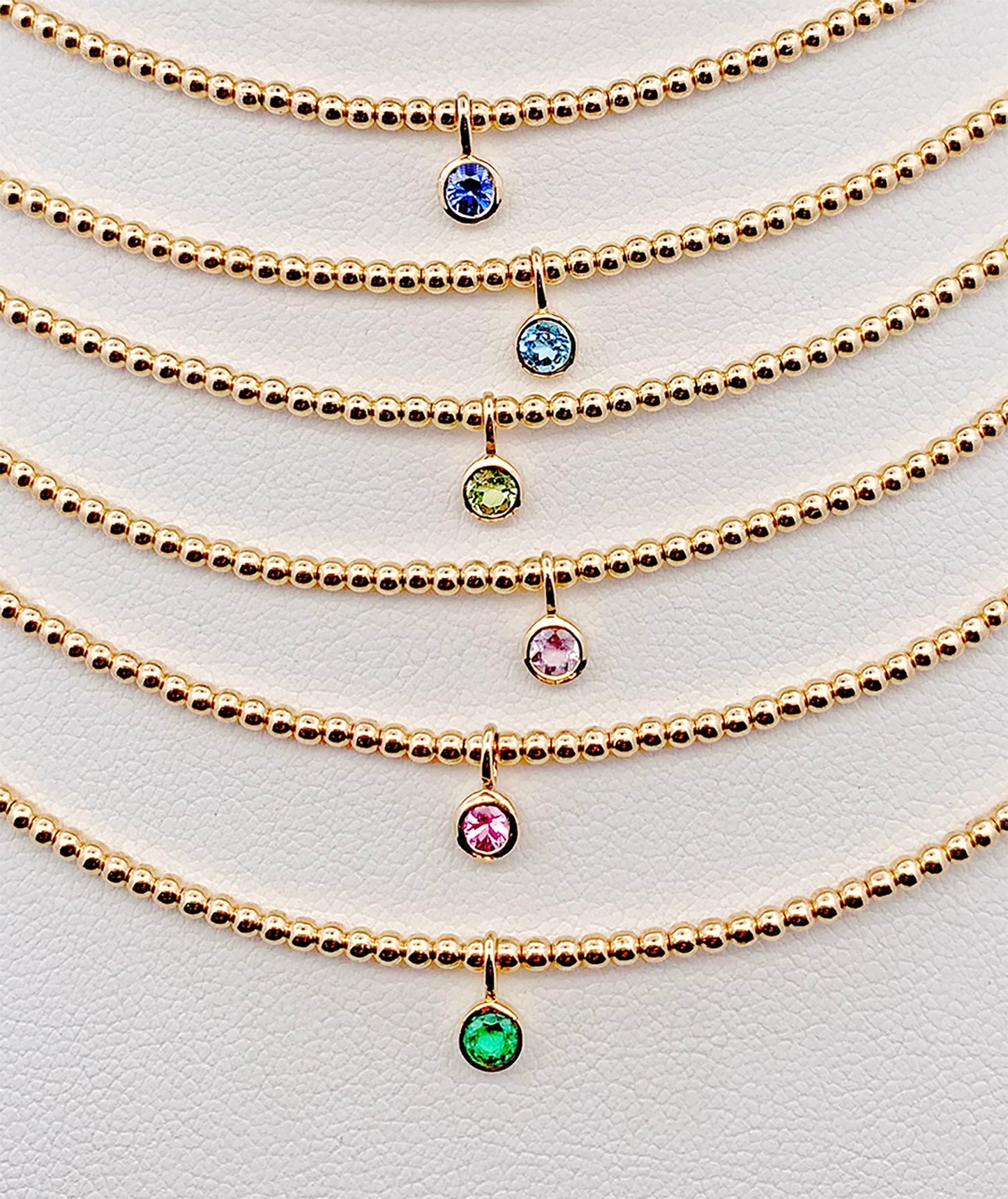 Gorgeous bezel set gemstone necklaces made with 14K gold-filled beads and 3/16" 14K bezel center gemstones made by Sayble Creations. Hand strung on nylon coated stainless steel beading wire with 14K gold-filled lobster clasp and 2" extender chain. Dimensions: 15" - 17" length Consciously made in California