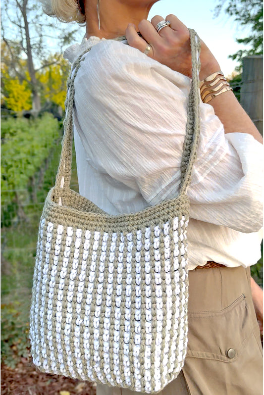 Summer in the south of France best describes the Mediterranean style, Canet crochet bucket bag, created by artisan extraordinaire, Oda G. Light weight, yet strong and durable with a cotton blend yarn in a two tone design. Two interior pockets are perfect to hold your phone and sunglasses separately, making this timeless chic bag a dream vacation companion. Dimensions: 9" high, 11" long, 7" wide, 20" high (with strap) Spot treat with mild soap or Dry Clean Consciously made in California