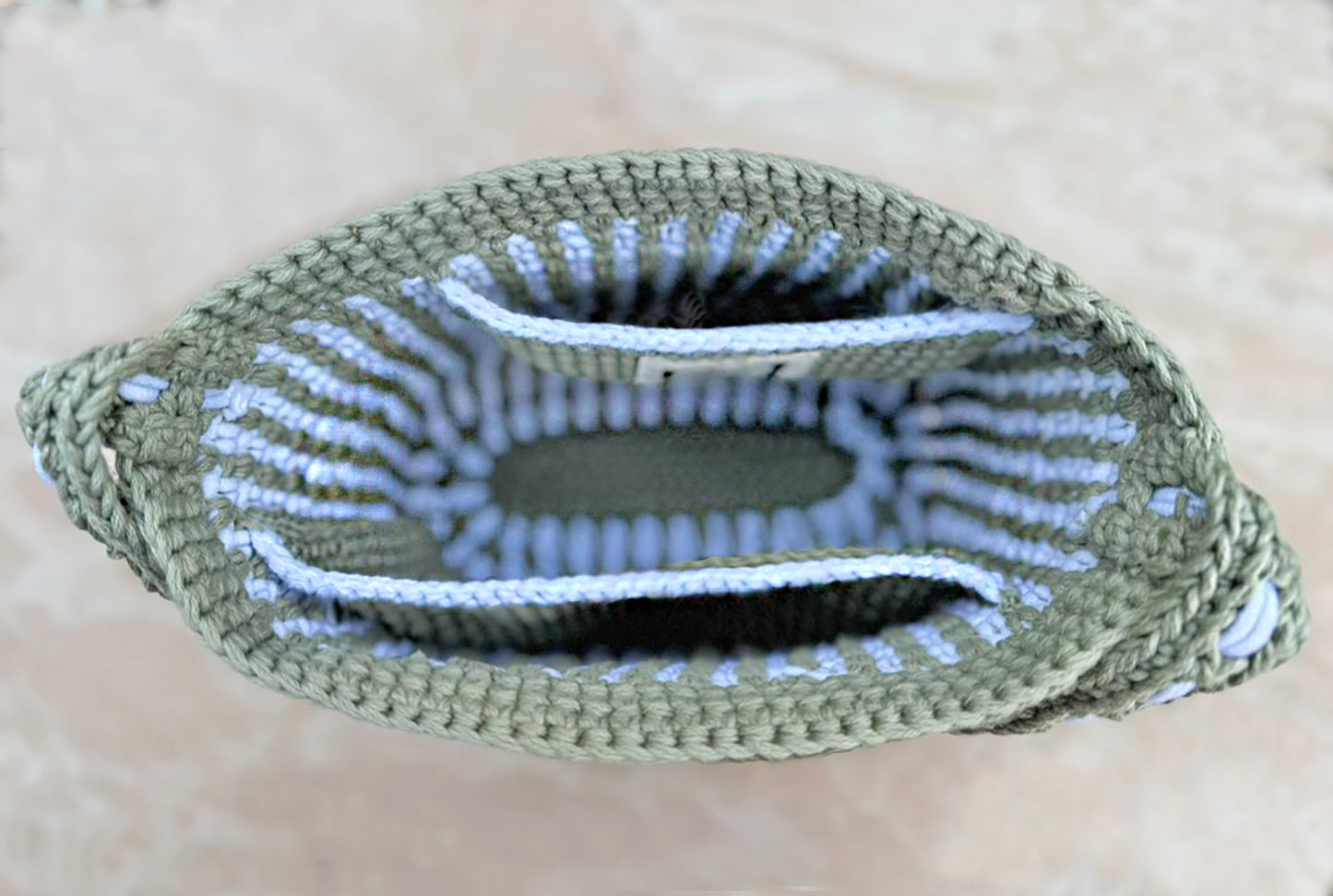 Summer in the south of France best describes the Mediterranean style, Canet crochet bucket bag, created by artisan extraordinaire, Oda G. Light weight, yet strong and durable with a cotton blend yarn in a two tone design. Two interior pockets are perfect to hold your phone and sunglasses separately, making this timeless chic bag a dream vacation companion. Dimensions: 9" high, 11" long, 7" wide, 20" high (with strap) Spot treat with mild soap or Dry Clean Consciously made in California