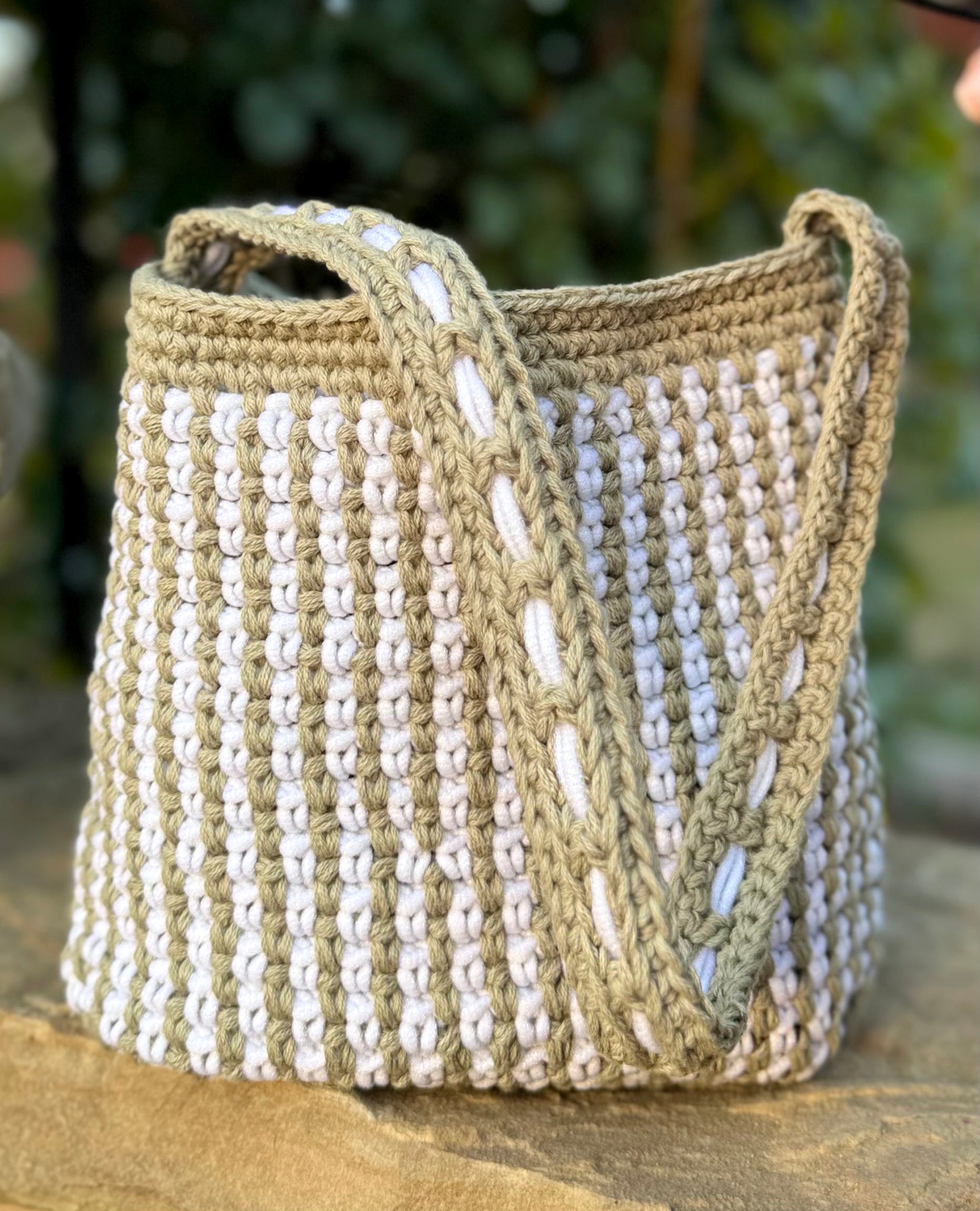 Summer in the south of France best describes the Mediterranean style, Canet crochet bucket bag, created by artisan extraordinaire, Oda G. Light weight, yet strong and durable with a cotton blend yarn in a two tone design. Two interior pockets are perfect to hold your phone and sunglasses separately, making this timeless chic bag a dream vacation companion. Dimensions: 9" high, 11" long, 7" wide, 20" high (with strap) Spot treat with mild soap or Dry Clean Consciously made in California