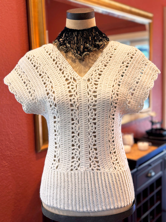 Italian inspired, the Murano crochet top is a timeless piece that can go from casual day to evening glam. Open stitch design with V neck (front & back) and scalloped edge short sleeves draping the shoulders. Made with upcycled cotton/acrylic blend yarn in ivory and impeccable craftsmanship by Oda G., this boho chic eye-catcher is a perfect addition to your wardrobe. Size: Small/Med., Length: 23" Hand Wash Cold or Dry Clean Consciously made in California