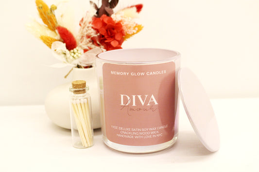 Indulge in a luxurious blend of Diva and Reign Memory Glow Candles. 11 oz. hand poured with long lasting soy wax, natural wood wick, and exquisite ingredients. Dedicated to those touched by Alzheimer's, we honor our matriarch's enduring spirit, which continues to inspire and guide us. Diva Amour: Clean, ozone, fruity green top notes with jasmine, lily of the valley, mid notes of lavender, bottom notes of wood, earth, and musk. Reign 540: Saffron, jasmine & crystal vanilla, balanced with rich suede, amber & 