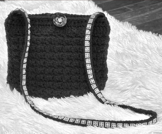 Evening sparkle of silver or gold add a beautiful accent to these vintage evening crochet bags. Each bag unique in reflecting the beauty of expert craftsmanship with up-cycled acrylic & metallic yarn, button closures from the 60s, black satin lining, and shoulder strap style that can also be worn cross body. Dimensions: Silver 'Elle' Bag: 8.5" long, 7" high, 4.5 wide, 16"strap Gold 'Eloise' Bag: 9"long, 10" high, 5" wide, 18" strap (from shoulder to top of bag) Dry Clean only Available for custom color orde