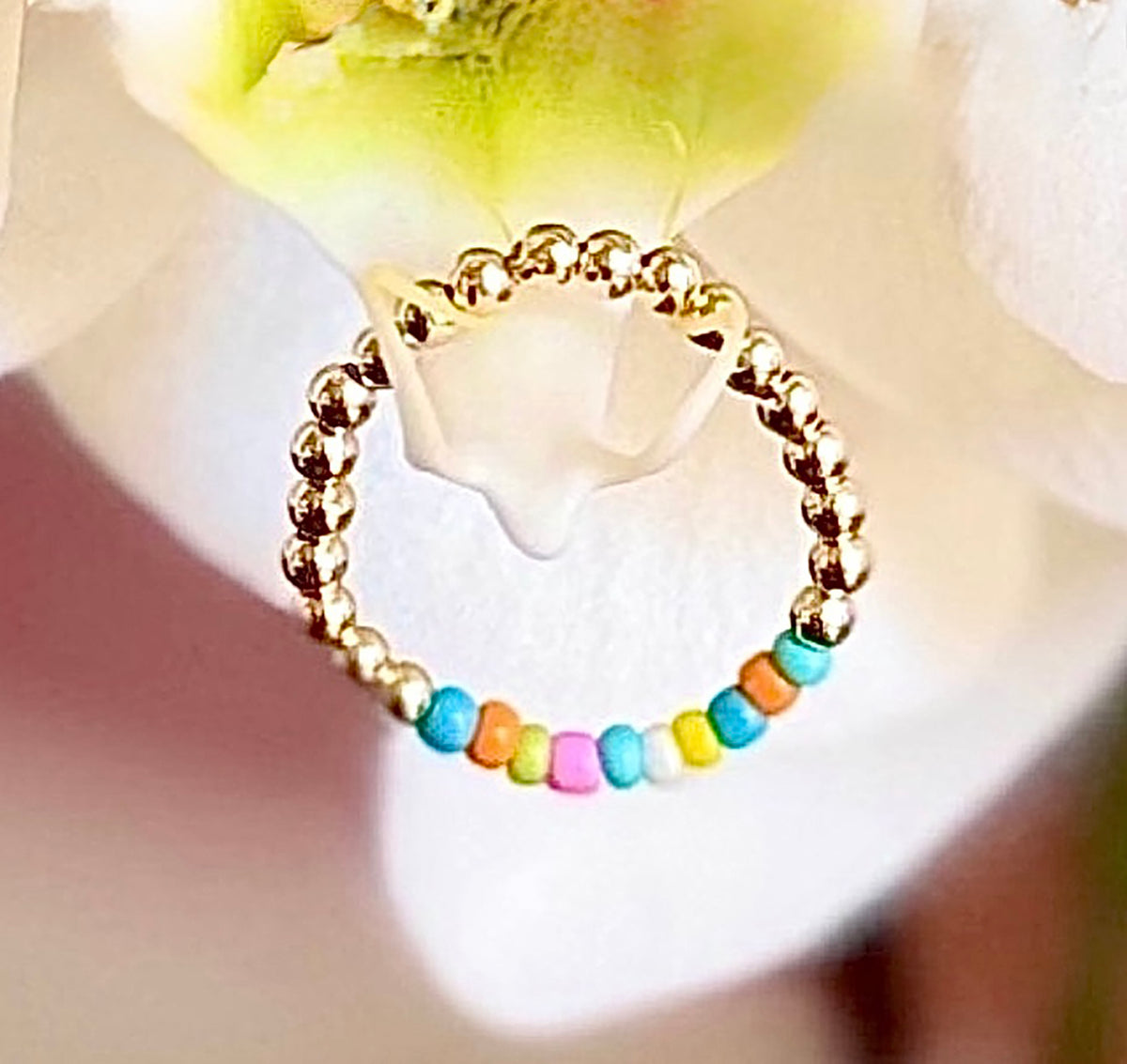 A burst of color is what's on the runway this fall/winter into next year's spring/summer season. 14K gold-filled beaded ring accented with vibrant, multicolored Ethiopian opal beads, strung on 1mm nylon elastic that fits most finger sizes. Beautifully handcrafted by Sayble Creations, wear individually or stack all three. Styles: Un - One part opal beads. Deux - Two parts opal beads. Trois - Three parts opal beads. Clean with soft cleaning cloth. Consciously made in California.
