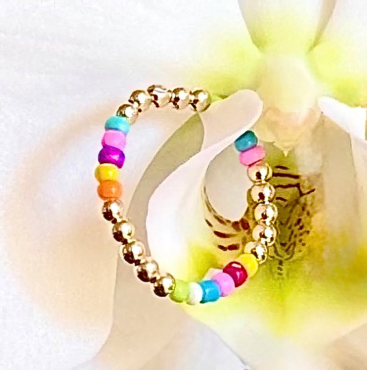 A burst of color is what's on the runway this fall/winter into next year's spring/summer season. 14K gold-filled beaded ring accented with vibrant, multicolored Ethiopian opal beads, strung on 1mm nylon elastic that fits most finger sizes. Beautifully handcrafted by Sayble Creations, wear individually or stack all three. Styles: Un - One part opal beads. Deux - Two parts opal beads. Trois - Three parts opal beads. Clean with soft cleaning cloth. Consciously made in California.