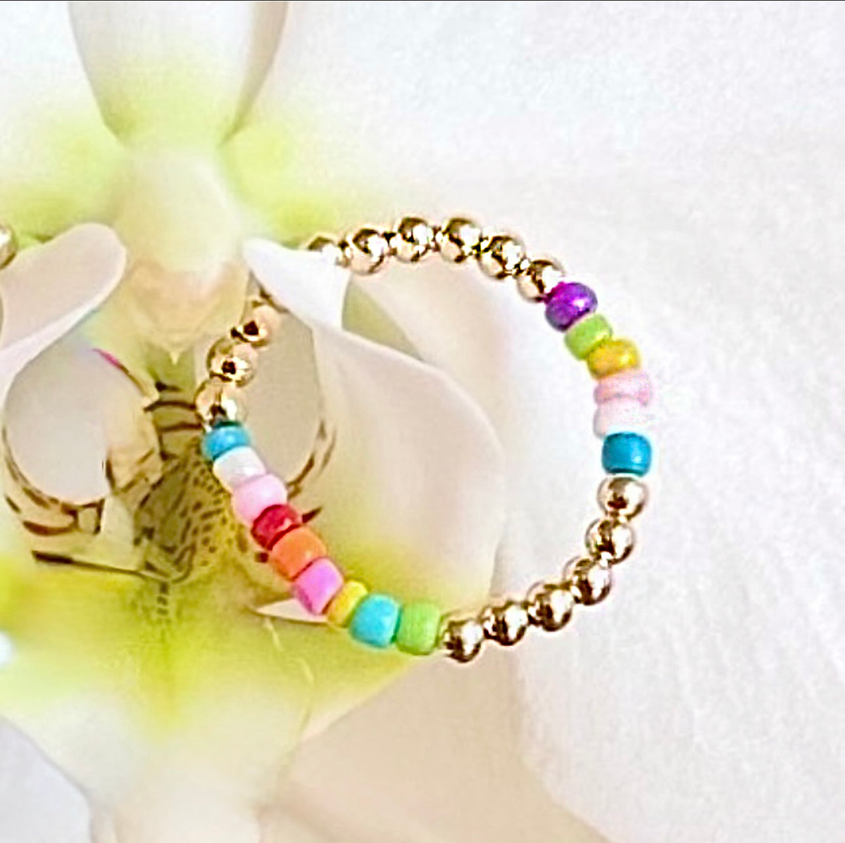 A burst of color is what's on the runway this fall/winter into next year's spring/summer season. 14K gold-filled beaded ring accented with vibrant, multicolored Ethiopian opal beads, strung on 1mm nylon elastic that fits most finger sizes. Beautifully handcrafted by Sayble Creations, wear individually or stack all three. Styles: Un - One part opal beads. Deux - Two parts opal beads. Trois - Three parts opal beads. Clean with soft cleaning cloth. Consciously made in California.