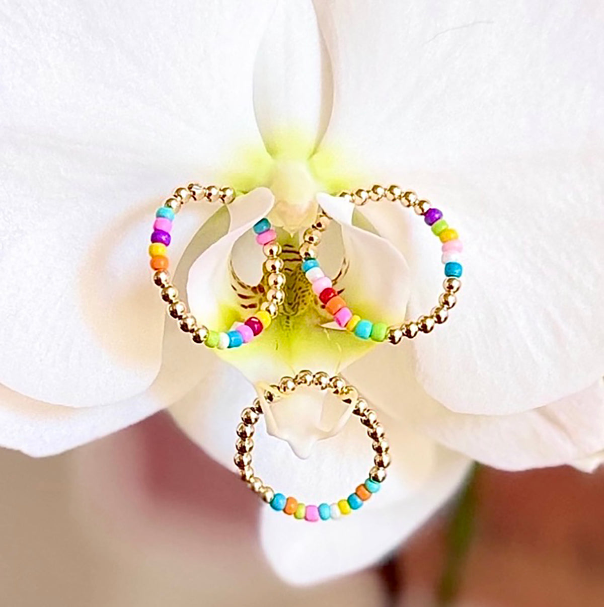 A burst of color is what's on the runway this fall/winter into next year's spring/summer season. 14K gold-filled beaded ring accented with vibrant, multicolored Ethiopian opal beads, strung on 1mm nylon elastic that fits most finger sizes. Beautifully handcrafted by Sayble Creations, wear individually or stack all three. Styles: Un - One part opal beads. Deux - Two parts opal beads. Trois - Three parts opal beads. Clean with soft cleaning cloth. Consciously made in California.