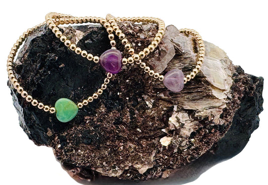 Wrap yourself in Love with Sayble Creations' Heart Bracelet Collection. Beautiful jewel tones in emerald, amethyst and rose quartz gemstones, and magnificent mother of pearl with 3mm 14K gold-filled beads hand strung on 1mm elastic. Dimensions: One size fits most. Handmade with Love in California