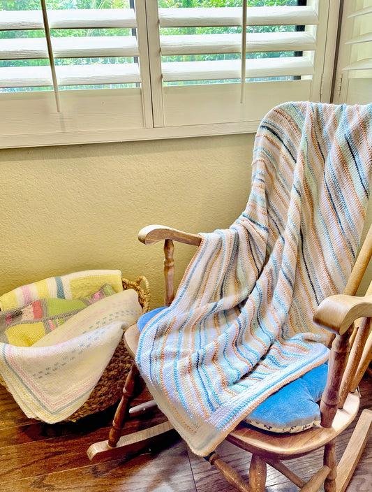 Malibu beach colors of pastel blues, greens, and earth tones are blended together in this soft, hand knit baby blanket.  A perfect one-of-a-kind gift for baby. 