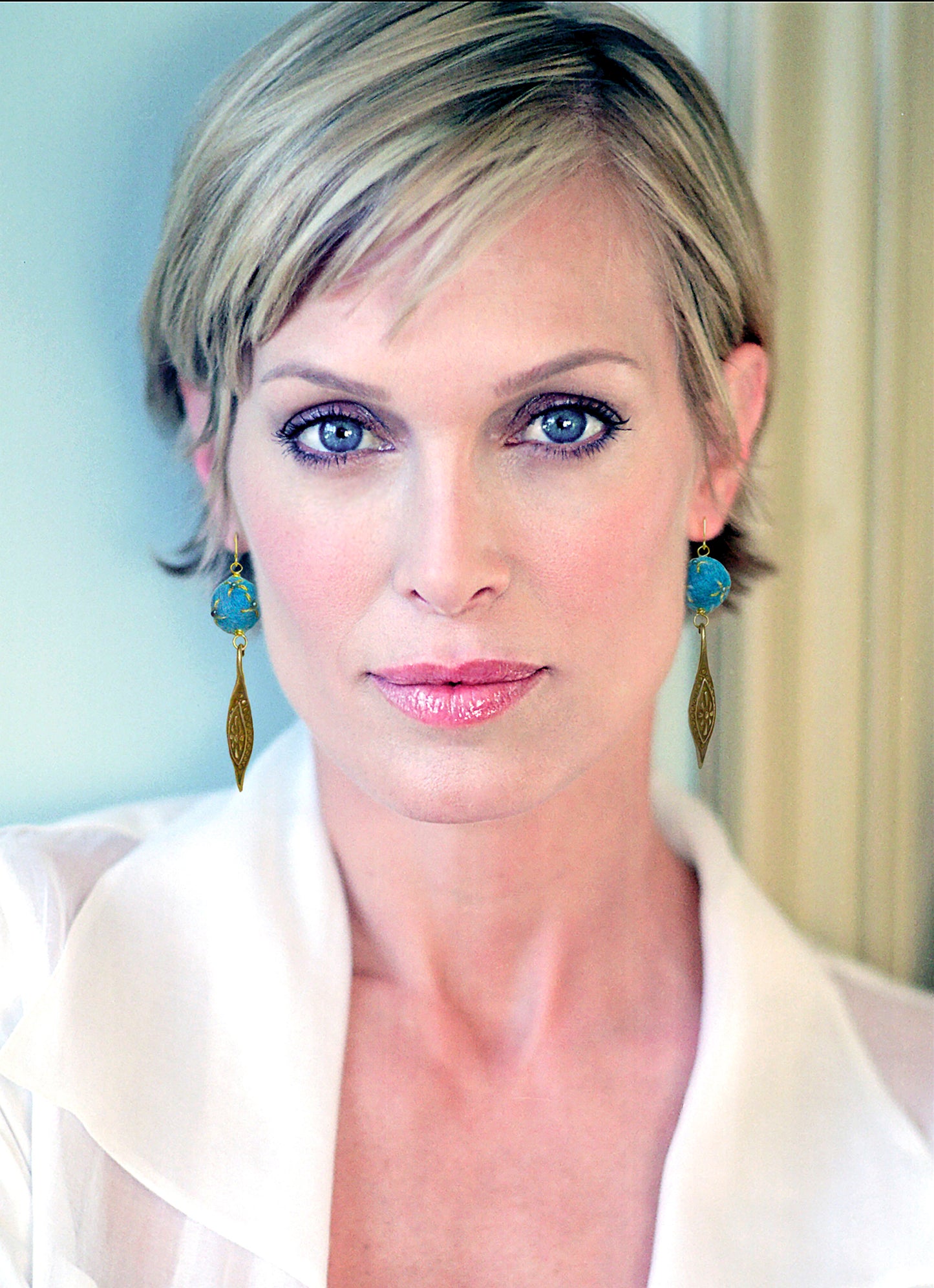 Red carpet or attending a black tie event, make a statement with these stunning drop earrings, handcrafted with the exquisite artistry of Iva Hladis. Elegant, one-of-a-kind 'Maytum' earrings are made with blue wool into small balls, embellished with gold metallic thread, freshwater cultured pearls, and brass earwire pendant. 