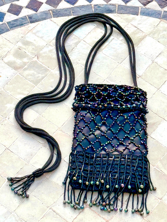 A perfect combination of sparkle and size with vintage style Mini Monaco and Classic Cannes crocheted bags. A favorite for a night out dancing. The Mini Monaco is lined with black satin fabric, hand beaded mesh with tiny colorful beads, beaded fringe on the bottom and beaded tassle at the end of the cross body strap. The Classic Cannes is unlined with a secure crochet pattern that insures better stretch if you need to add more in your bag. Up-cycled silver metallic acrylic yarn, vintage chrome button closur