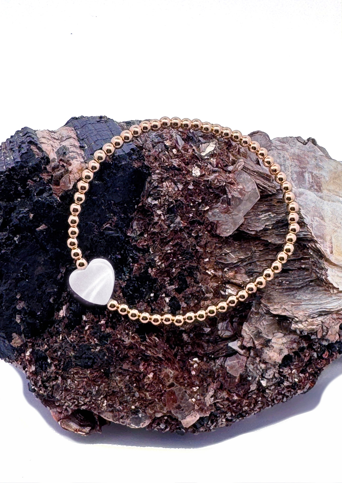 Wrap yourself in Love with Sayble Creations' Heart Bracelet Collection. Beautiful jewel tones in emerald, amethyst and rose quartz gemstones, and magnificent mother of pearl with 3mm 14K gold-filled beads hand strung on 1mm elastic. Dimensions: One size fits most. Handmade with Love in California