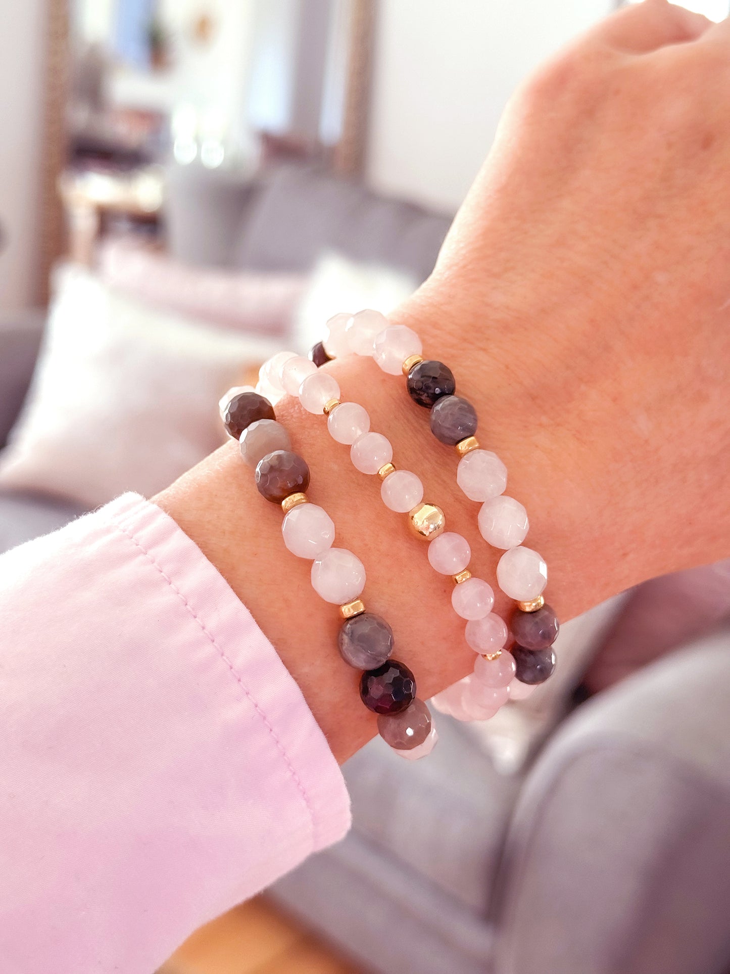 Feel good and look beautiful in 'Just Good JuJu' gemstone trio bracelets. The trio of Amazonite with sterling silver bead accents, has powerful healing properties, encouraging emotional balance, harmony, good luck and fortune. The trio of Rose Quartz and faceted petrified wood with 14k gold filled bead accents, has healing properties of calm, compassion and love. Each bracelet has stretch cord to fit most wrist sizes. Dimensions: Amazonite - (2) 8mm stones, silver bead accents, (1) 8mm stones with one 8mm s