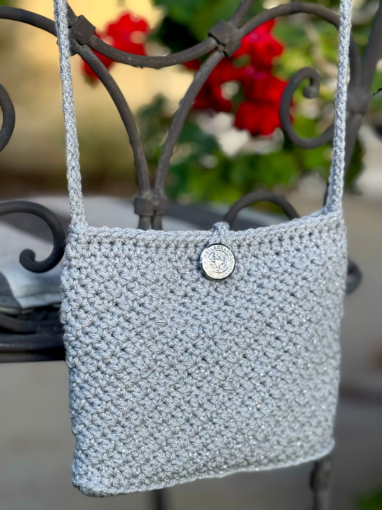A perfect combination of sparkle and size with vintage style Mini Monaco and Classic Cannes crocheted bags. A favorite for a night out dancing. The Mini Monaco is lined with black satin fabric, hand beaded mesh with tiny colorful beads, beaded fringe on the bottom and beaded tassle at the end of the cross body strap. The Classic Cannes is unlined with a secure crochet pattern that insures better stretch if you need to add more in your bag. Up-cycled silver metallic acrylic yarn, vintage chrome button closur