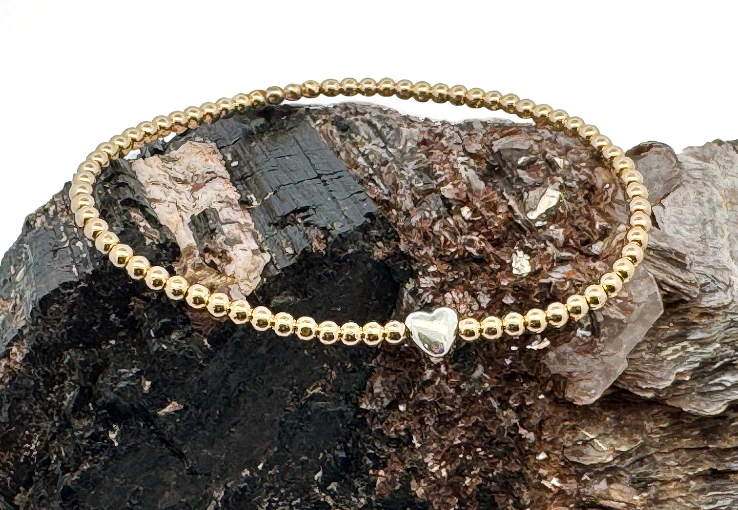 "All we need is Love"... Sterling silver puff heart' with 14K gold-filled beads are available as a bracelet, ring, and spinel / sterling silver with black sapphire beads necklace, strung on 1mm nylon elastic. These beautiful treasures are a perfect gift for your loved ones, or a little reminder to love oneself. Dimensions: 3mm 14K gold filled beads - one size fits most. Handmade with Love in California