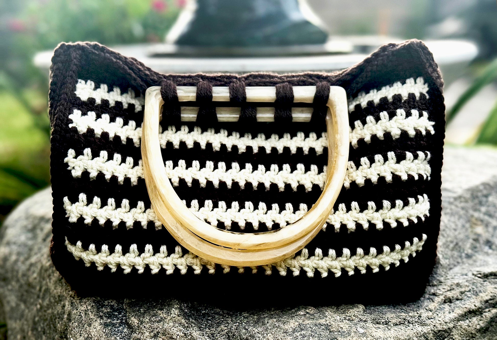 Italian vintage style Sienna Bag takes us back to the 60's, with cream color lucite handles, and acrylic yarn, hand crocheted in a striped pattern. Dimensions: Bag - 11" wide, 9" high, Handles - 5.5" x 5" Hand wash with mild soap, cold water, or Dry Clean Made in the USA