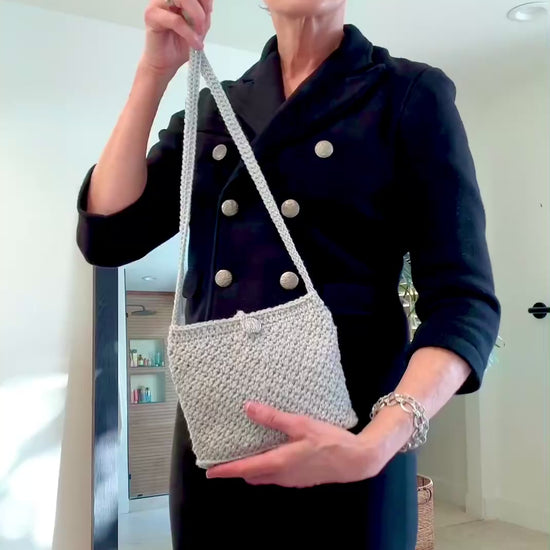 A perfect combination of sparkle and size with vintage style Mini Monaco and Classic Cannes crocheted bags. A favorite for a night out dancing. The Mini Monaco is lined with black satin fabric, hand beaded mesh with tiny colorful beads, beaded fringe on the bottom and beaded tassle at the end of the cross body strap. The Classic Cannes is unlined with a secure crochet pattern that insures better stretch if you need to add more in your bag. Up-cycled silver metallic acrylic yarn, vintage chrome button closur